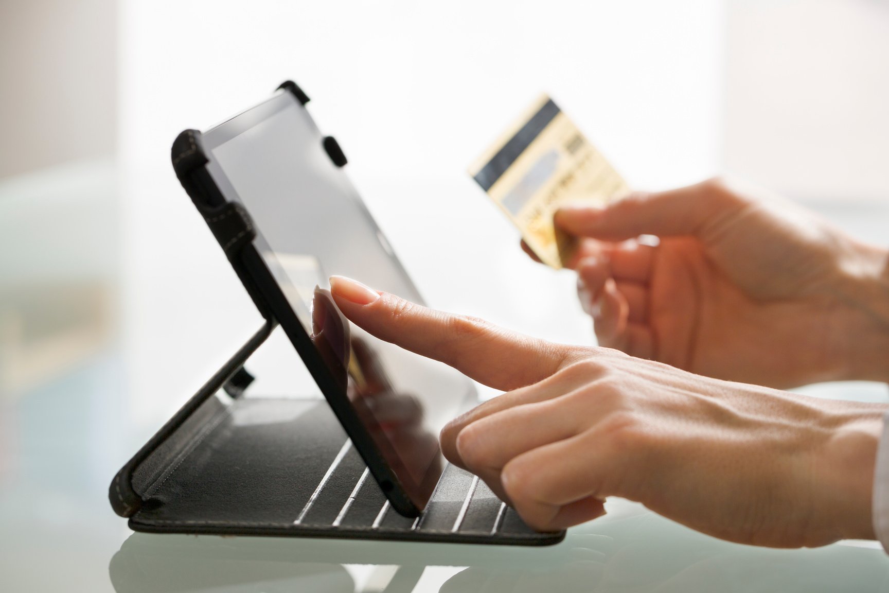 Woman shopping using tablet pc and credit card .indoor.close-up